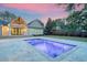 Backyard view showcasing a modern pool with vibrant purple lighting and a covered outdoor space at 422 Palm St, Mount Pleasant, SC 29464