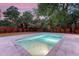 Backyard view of pool with stone surround and mature landscaping at 422 Palm St, Mount Pleasant, SC 29464