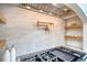Range hood with pot filler over a professional stove with marble backsplash and wooden shelves on the side at 422 Palm St, Mount Pleasant, SC 29464