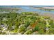 Aerial view of a beautiful home surrounded by lush trees, with stunning marsh views in the background at 474 Woodspring Rd, Mount Pleasant, SC 29466