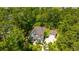 A high aerial view of a gray two-story home, separate garage, lush green trees, lawn, and bay in the distance at 474 Woodspring Rd, Mount Pleasant, SC 29466