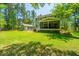 A screened porch overlooks the spacious, grassy backyard with a detached garage at 474 Woodspring Rd, Mount Pleasant, SC 29466