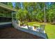 Outdoor patio space with rocking chairs, stainless steel grill and view of mature trees at 474 Woodspring Rd, Mount Pleasant, SC 29466