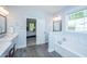 Bright and modern bathroom with soaking tub and an open doorway to the main bedroom at 474 Woodspring Rd, Mount Pleasant, SC 29466