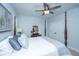A well decorated bedroom featuring a four poster bed, ceiling fan and dresser with mirror at 474 Woodspring Rd, Mount Pleasant, SC 29466
