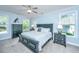 Light and bright bedroom with carpeted floor, ceiling fan, two windows and nice furnishings at 474 Woodspring Rd, Mount Pleasant, SC 29466