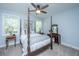 Elegant bedroom featuring a four-poster bed, natural light, and neutral decor at 474 Woodspring Rd, Mount Pleasant, SC 29466