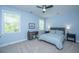 Bedroom with a bed, desk, ceiling fan, carpeted floor, and plenty of natural light at 474 Woodspring Rd, Mount Pleasant, SC 29466
