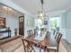 Spacious dining room with wainscoting, chandelier, and large table for entertaining at 474 Woodspring Rd, Mount Pleasant, SC 29466