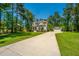 Beautiful two-story home with lush green lawn, detached garage and basketball court at 474 Woodspring Rd, Mount Pleasant, SC 29466