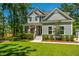 Charming two-story home with a covered porch and landscaped yard featuring a grey exterior at 474 Woodspring Rd, Mount Pleasant, SC 29466