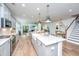 Open kitchen with stainless steel appliances, an island, and views of the living area at 474 Woodspring Rd, Mount Pleasant, SC 29466