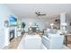 Open living area with fireplace and shiplap detail, ceiling fan, and view to the staircase at 474 Woodspring Rd, Mount Pleasant, SC 29466
