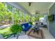 Relaxing screened porch featuring comfortable seating, ceiling fans, and views of the lush backyard at 474 Woodspring Rd, Mount Pleasant, SC 29466