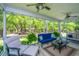 A well decorated screened porch with comfortable seating, ceiling fan and wooded views at 474 Woodspring Rd, Mount Pleasant, SC 29466