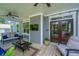 Cozy screened porch with a mounted television, wood floors, and easy access to the outdoors at 474 Woodspring Rd, Mount Pleasant, SC 29466