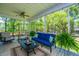 A well decorated screened porch with comfortable seating, ceiling fan and wooded views at 474 Woodspring Rd, Mount Pleasant, SC 29466