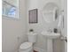 Bathroom featuring a modern pedestal sink, stylish mirror, and neutral decor at 488 Queenview Ln, Charleston, SC 29414