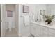 Well-lit bathroom with white cabinets, a large mirror, a towel rack, and a separate toilet room at 488 Queenview Ln, Charleston, SC 29414