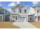 Charming two-story home with gray siding, a white garage door, and well-manicured front yard at 488 Queenview Ln, Charleston, SC 29414