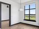 Bright bedroom featuring a large window overlooking a park, and hardwood floors at 5 Gadsdenboro St # 503, Charleston, SC 29401