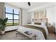 Staged bedroom featuring a bed, ceiling fan, and a large window showcasing a water view at 5 Gadsdenboro St # 503, Charleston, SC 29401
