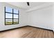 Light bedroom featuring hardwood floors and a large window showcasing a water view at 5 Gadsdenboro St # 503, Charleston, SC 29401