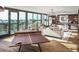 Bright game room with table tennis and a cozy seating area with floor-to-ceiling windows and city views at 5 Gadsdenboro St # 503, Charleston, SC 29401