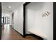Stylish hallway with hardwood floors and custom built-in nook with black trim for a touch of modern elegance at 5 Gadsdenboro St # 503, Charleston, SC 29401