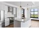 Bright kitchen with stainless steel appliances, gold fixtures, and chevron backsplash at 5 Gadsdenboro St # 503, Charleston, SC 29401