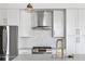 Stylish kitchen features stainless steel appliances, sleek white cabinets, and a designer backsplash at 5 Gadsdenboro St # 503, Charleston, SC 29401