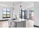 Modern kitchen island with stainless steel appliances, gold fixtures, and bright natural light at 5 Gadsdenboro St # 503, Charleston, SC 29401