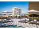 Luxurious rooftop terrace with a pool, lounge chairs, dining areas, and stunning views of the city skyline at 5 Gadsdenboro St # 503, Charleston, SC 29401
