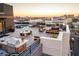 Expansive rooftop deck featuring a pool, grilling station, fire pit, and lounge seating with amazing city views at 5 Gadsdenboro St # 503, Charleston, SC 29401