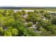 This aerial view shows a neighborhood near a body of water with mature trees and various home styles at 5 S Basilica Ave, Hanahan, SC 29410