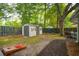 Fenced backyard with a storage shed, lush greenery, and mature trees at 5 S Basilica Ave, Hanahan, SC 29410