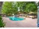 Backyard with inviting pool, lounge area, mature trees, and lush greenery at 5 S Basilica Ave, Hanahan, SC 29410