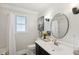 Well-lit bathroom featuring a vanity, a round mirror, and stylish decor at 5 S Basilica Ave, Hanahan, SC 29410
