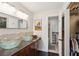 Bathroom with double bowl sinks, granite countertops, and tiled walk-in shower at 5 S Basilica Ave, Hanahan, SC 29410
