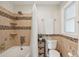 Cozy bathroom featuring stylish tile work, shower, and natural light from the window at 5 S Basilica Ave, Hanahan, SC 29410