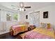 Inviting bedroom showcasing twin beds, a ceiling fan, and a large world map decor at 5 S Basilica Ave, Hanahan, SC 29410