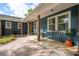 Charming courtyard showcasing home's exterior with a covered porch and inviting seating at 5 S Basilica Ave, Hanahan, SC 29410