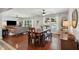 Open-concept dining area with wood floors, backyard views, and a ceiling fan at 5 S Basilica Ave, Hanahan, SC 29410