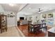 Bright dining area with wood floors, a dining table, and pool views through the window at 5 S Basilica Ave, Hanahan, SC 29410