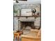 Close-up of the stone fireplace with a wooden mantel and decorative accents at 5 S Basilica Ave, Hanahan, SC 29410