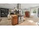 Open kitchen with center island, stainless steel appliances, stone backsplash and open concept to the living area at 5 S Basilica Ave, Hanahan, SC 29410