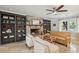 Comfortable living room featuring a stone fireplace, built-in shelving, and a ceiling fan at 5 S Basilica Ave, Hanahan, SC 29410