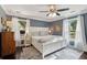 Comfortable main bedroom featuring blue walls, hardwood floors, and natural lighting at 5 S Basilica Ave, Hanahan, SC 29410