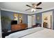 Comfortable main bedroom featuring blue walls, hardwood floors, and en-suite bathroom at 5 S Basilica Ave, Hanahan, SC 29410