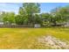 Expansive backyard with lush green grass and mature trees, perfect for outdoor activities and relaxation at 5163 W Dolphin St, North Charleston, SC 29405